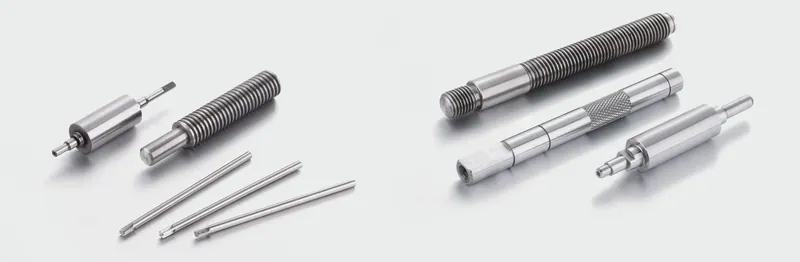 Threaded and knurled precision shafts arranged on a light background