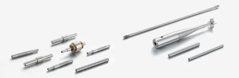 Threaded and stepped precision shafts on a light background